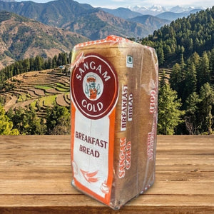 Bag of Sangam Gold Breakfast Bread on a wooden surface with a mountainous landscape in the background