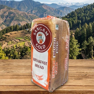 Bag of Sangam Gold Breakfast Bread on a wooden surface with a mountainous landscape in the background