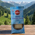 Winkies Classic Vanilla Slice Cake package on a wooden table with a mountainous landscape in the background